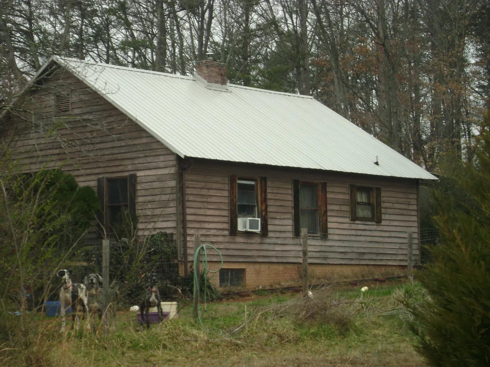 White metal roof on an old wood sided farmhouse, from a Metal Roof Installation job in Terrace Park